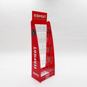 A red and white branded bespoke floorstanding brochure display with "ferment" branding.