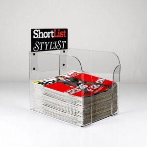 A PETG countertop magazine dump bin with a custom graphic header, with magazines on display.