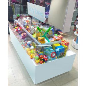 A white product merchandiser island with a selection of different toys inside.