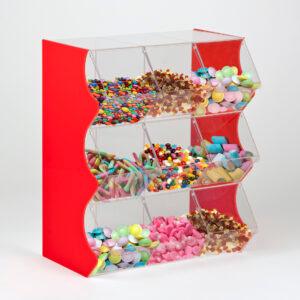 A red 9 container stacked pick and mix dispenser full of different unwrapped sweets.