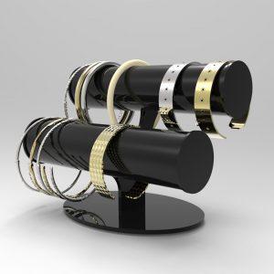 A black acrylic bracelet display with gold and silver bracelets and bangles on display.