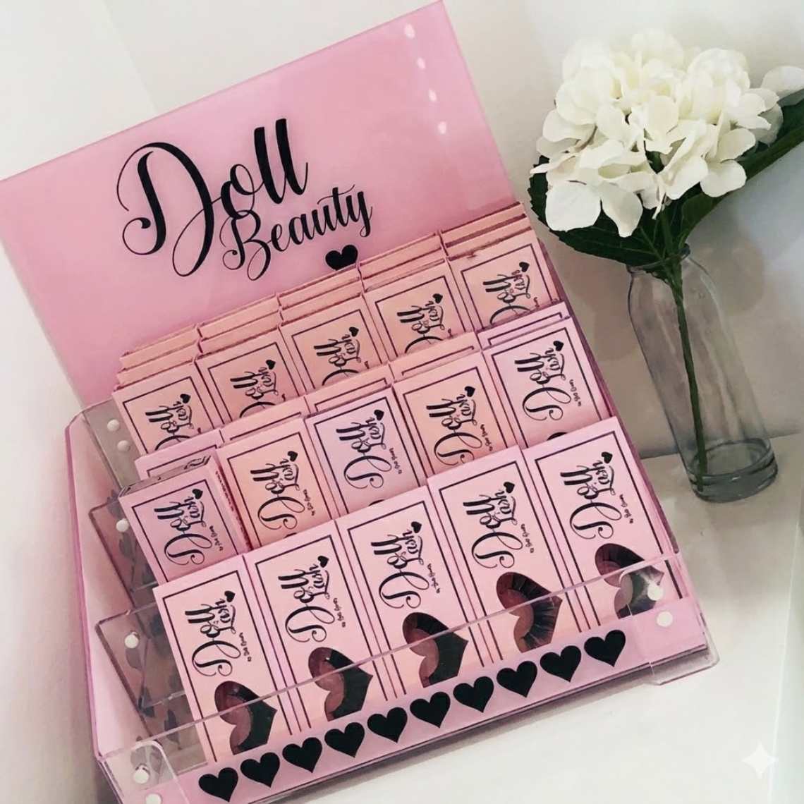 A custom POS eyelash display with Doll Beauty custom branding.