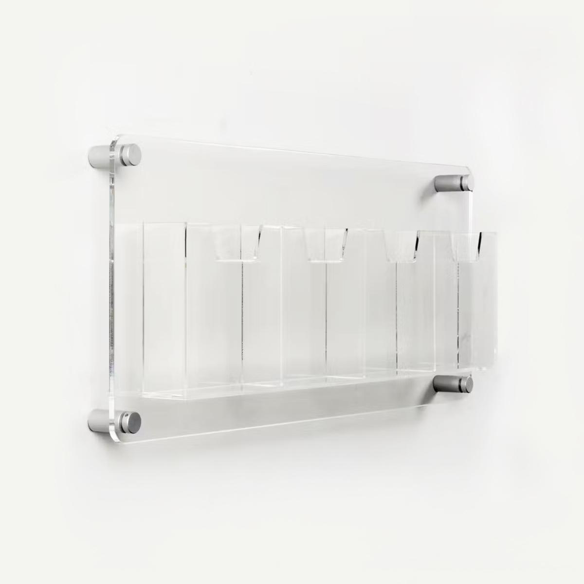 Clear acrylic wall mounted leaflet holder with four 1/3 A4 pockets.