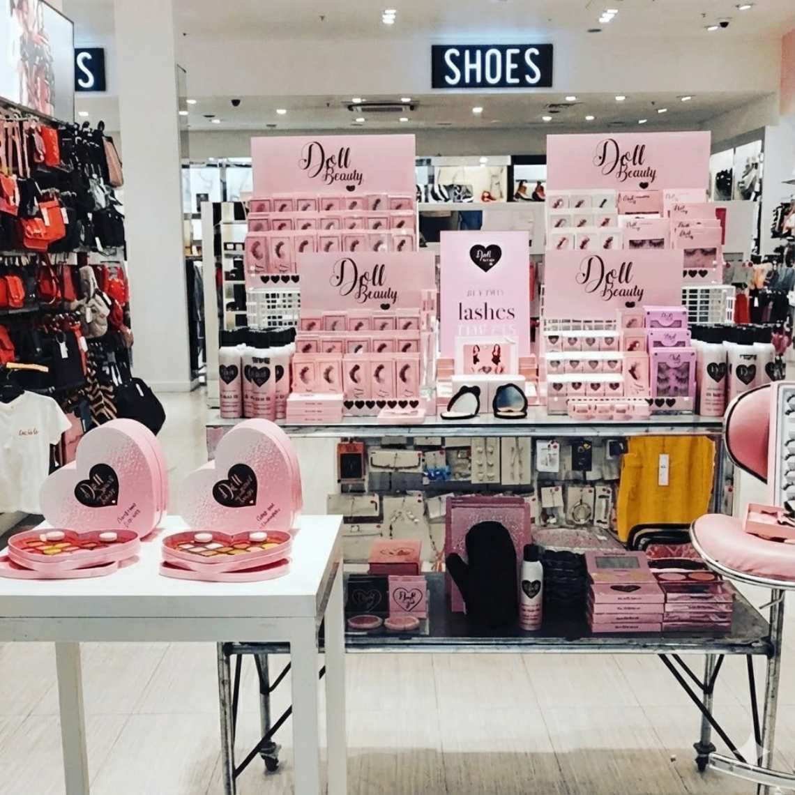 A Doll Beauty custom eyelash display in a beauty store.
