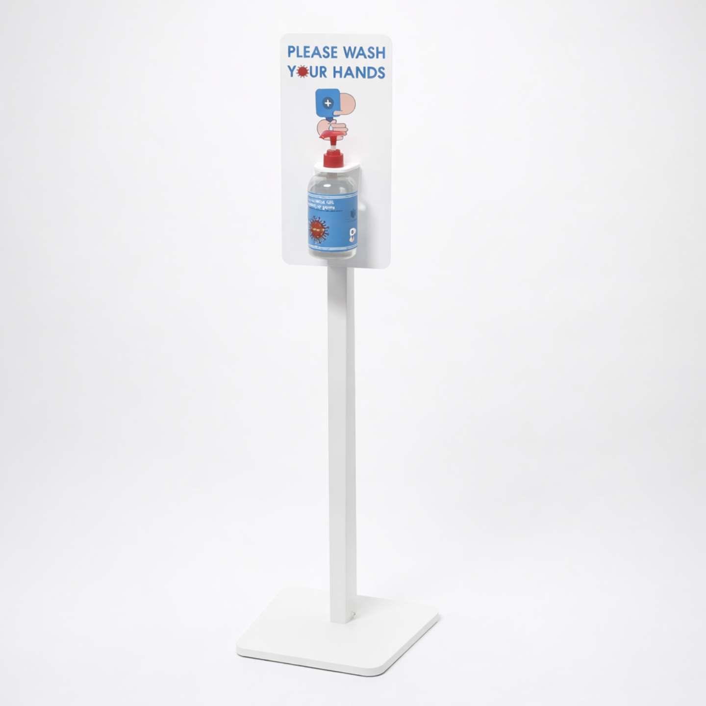 A freestanding hand sanister unit with header graphics and soap, facing the corner.