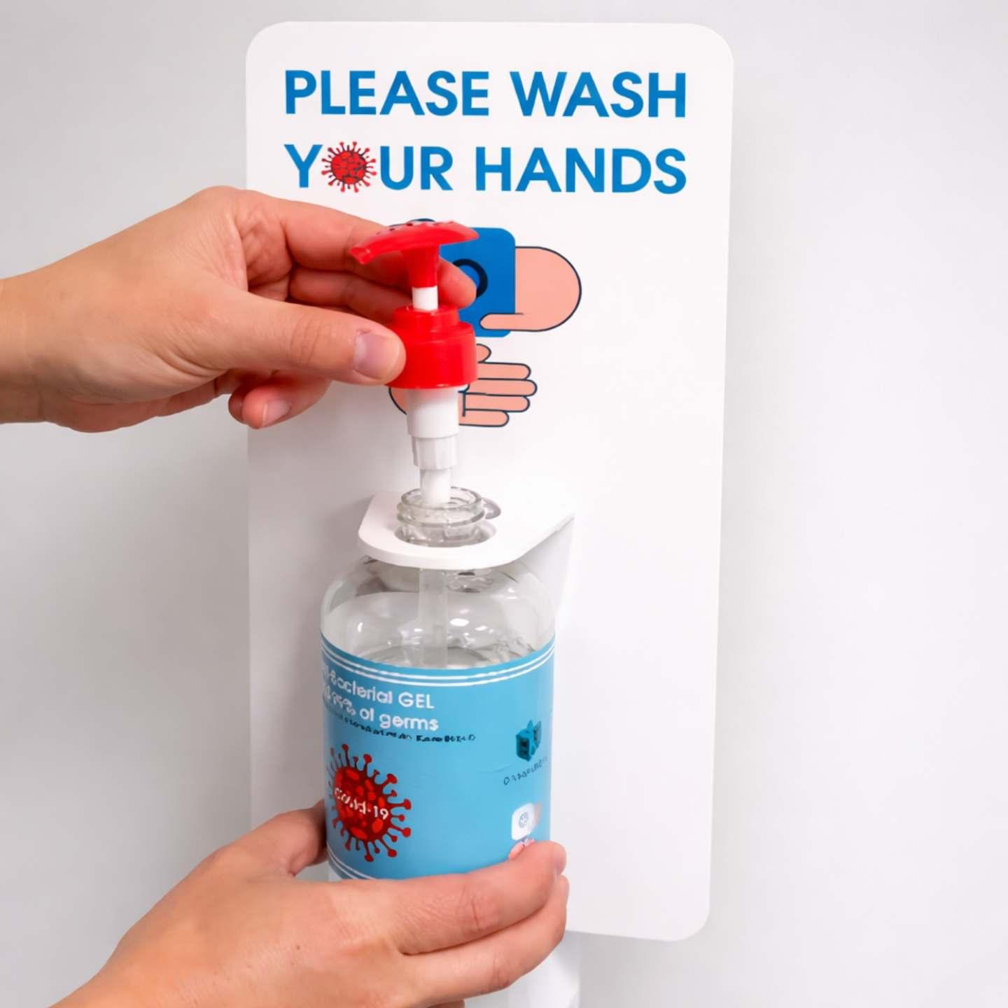 A close up of hands placing hand sanitiser in a hand sanitiser unit.