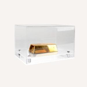 Model display case with clear top and white base with gold displayed inside.