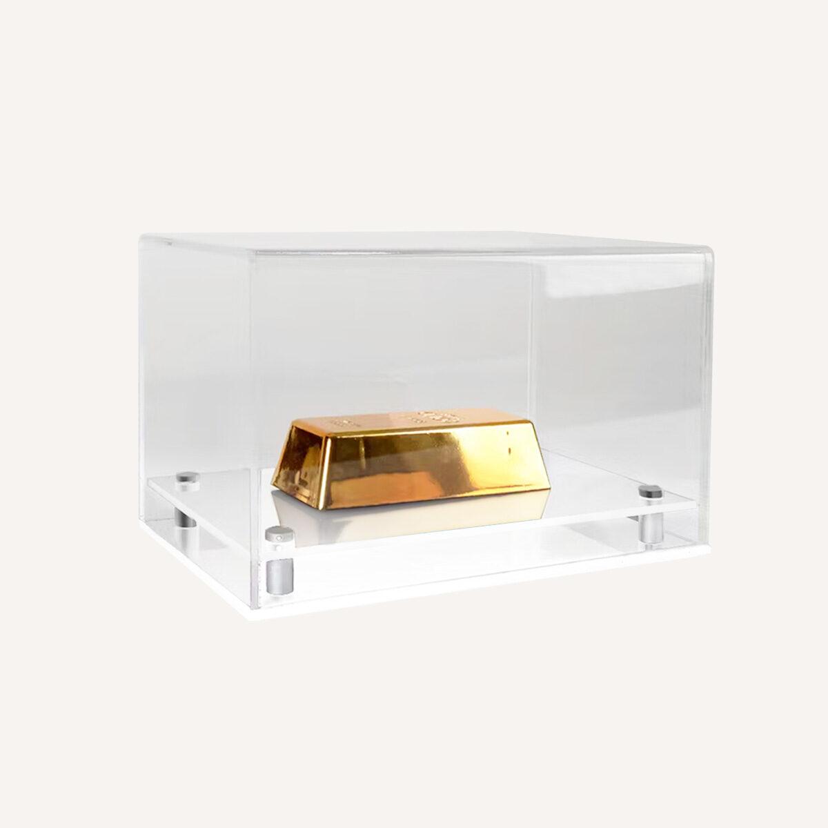 Model display case with clear top and white base with gold displayed inside.