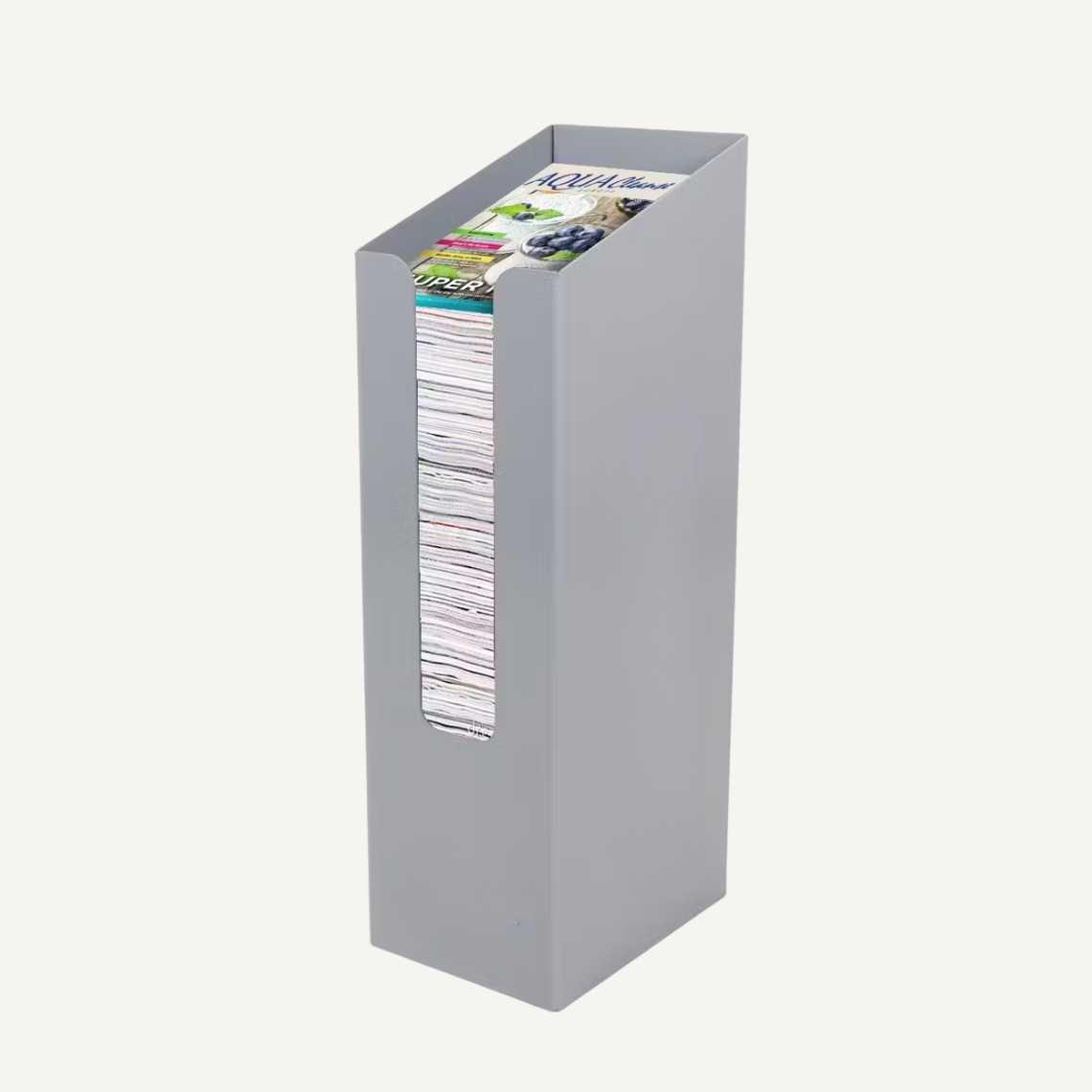 A grey metal dump bin with magazines inside.