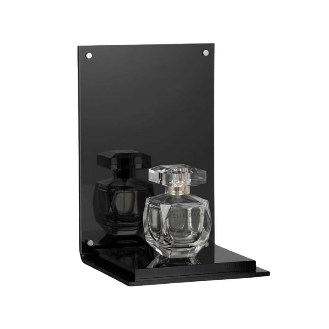 A black perfume display stand with a black platform and a perfume on display.
