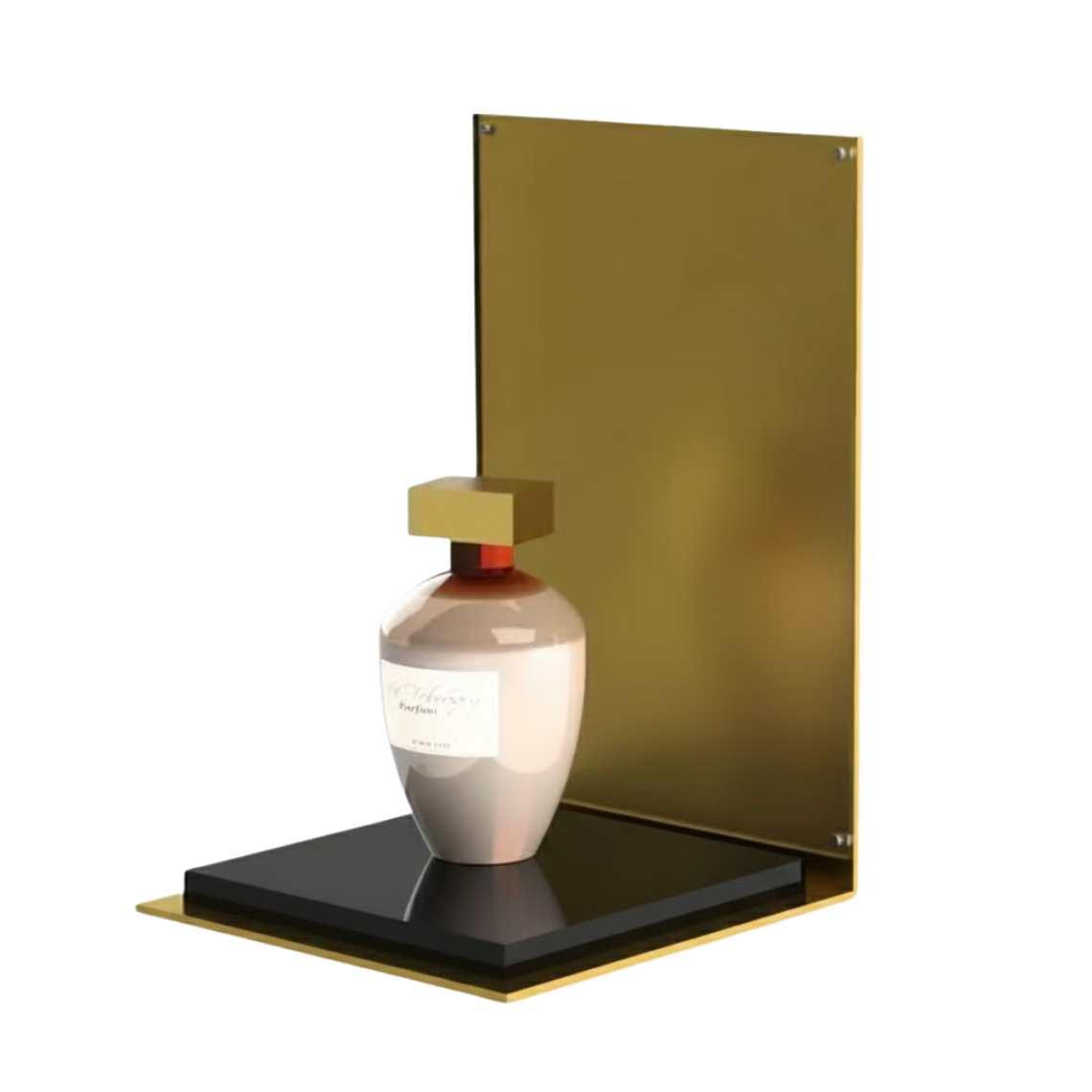 A gold perfume display stand with a black platform and a perfume on display.