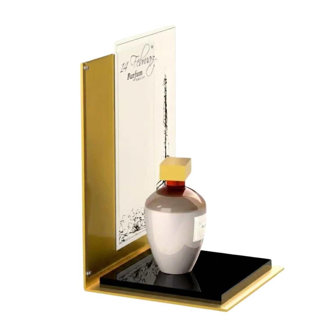 A gold perfume display stand with a black platform and a perfume and graphics on display.