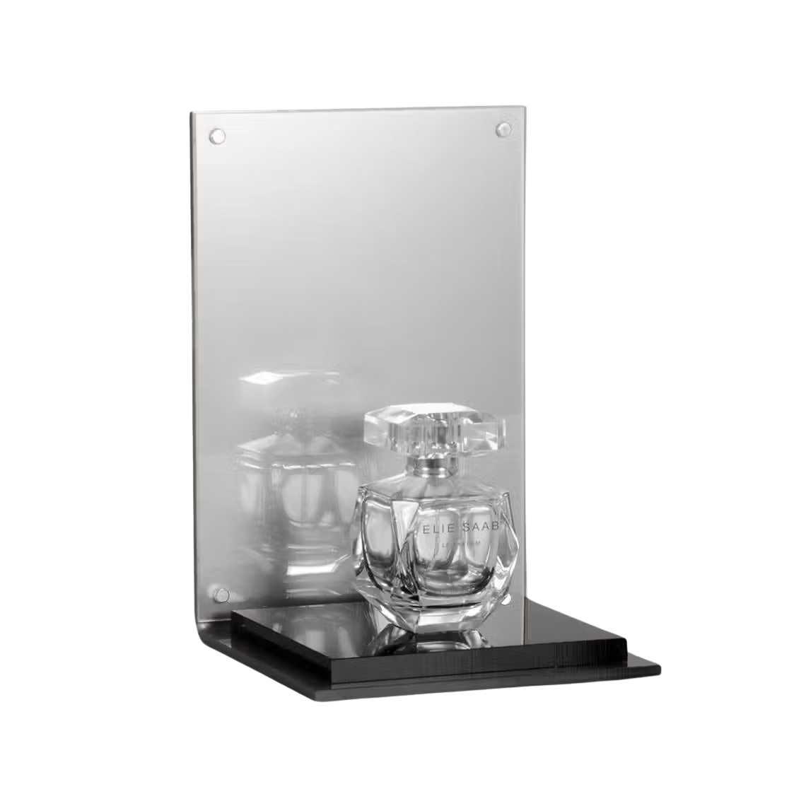 A silver perfume display stand with a black platform and a perfume on display.