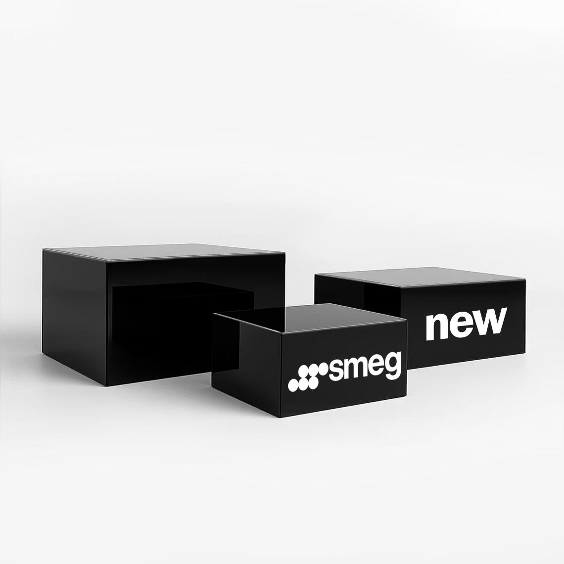 Black gloss display plinths featuring “SMEG” and “new” branding, designed for stylish retail product presentation.