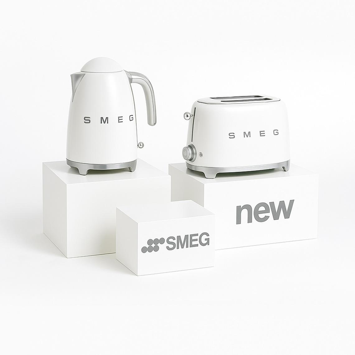 White gloss display plinths with SMEG kettle and toaster, showcasing branded retail display setup for kitchen products.