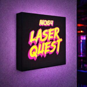 A brightly lit square lightbox mounted on a wall, displaying the neon-style text ‘NQ64 LASER QUEST’ in bold yellow and pink lettering, with the sign glowing against a softly textured purple wall.