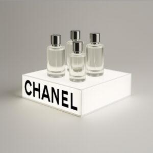 Countertop branded illuminated product display plinth, showcasing Chanel logo and displaying 4 perfume bottles.