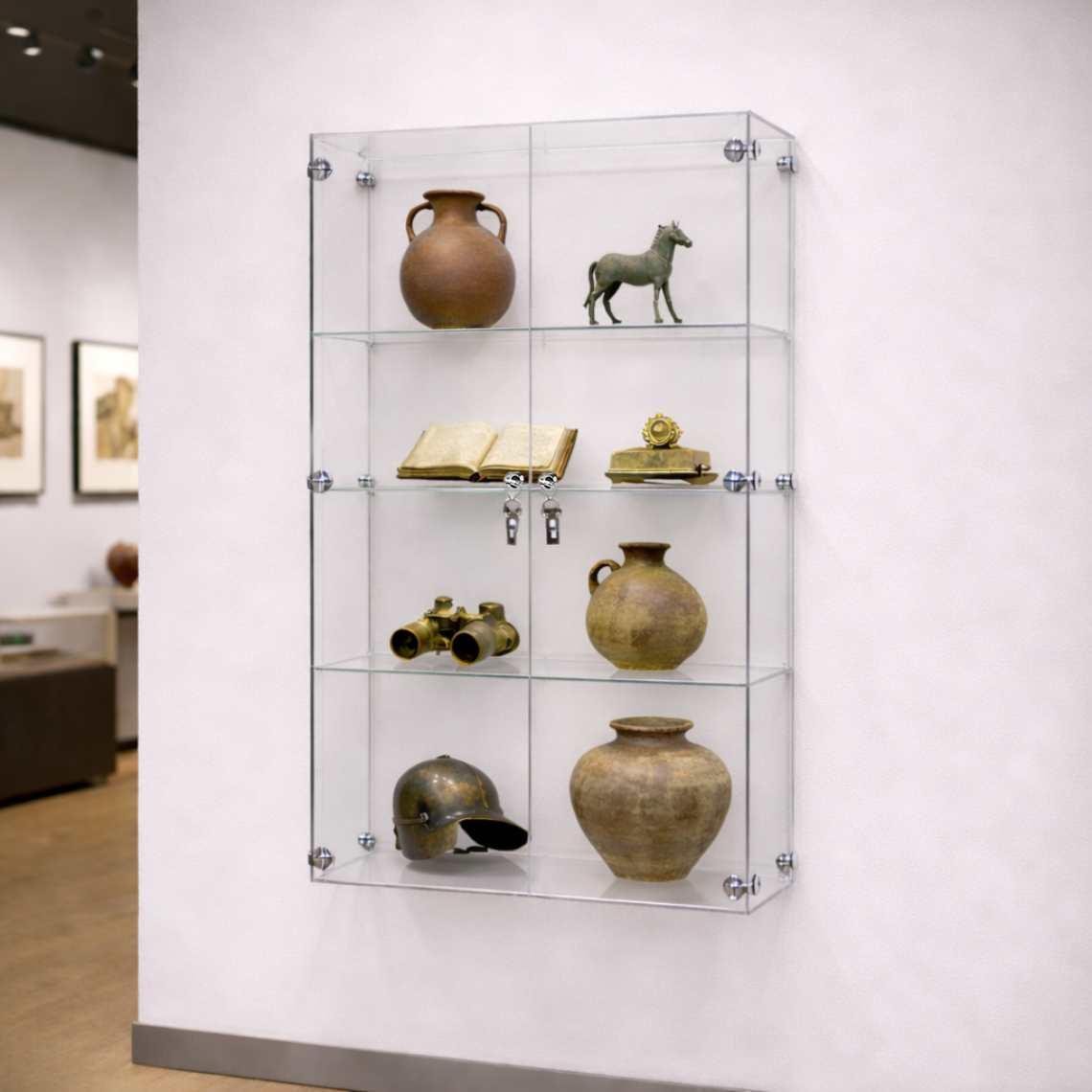 A wall mounted display cabinet in a museum with ornaments and vases inside.
