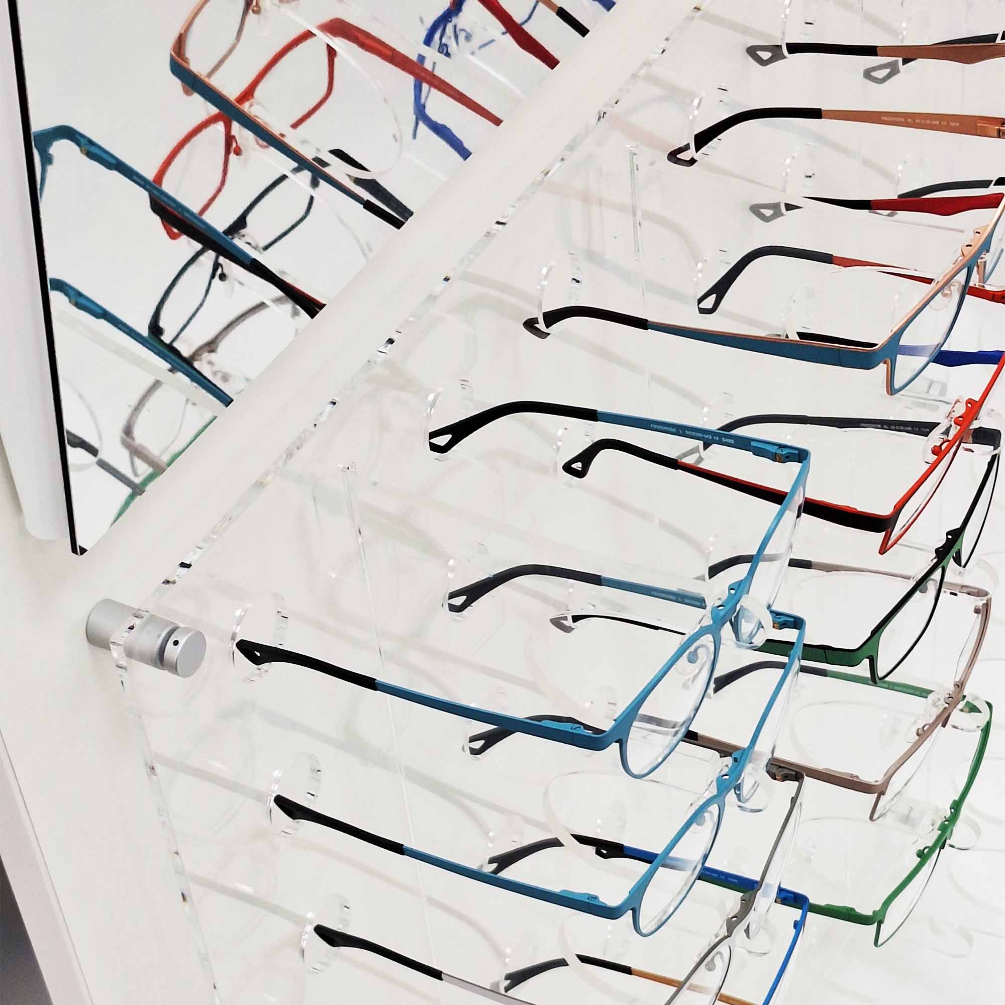 Detailed close-up of blue eyeglass frame on display stand, lightweight modern optical frame with clear nose pads and slim arms