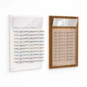 Modern eyewear display boards on white wall, white and wood finish optical frame holders with mirrors, retail glasses display for opticians