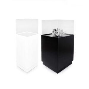 One white museum display case plinth and one black exhibition display case plinth featuring a tapered floating bottom design.
