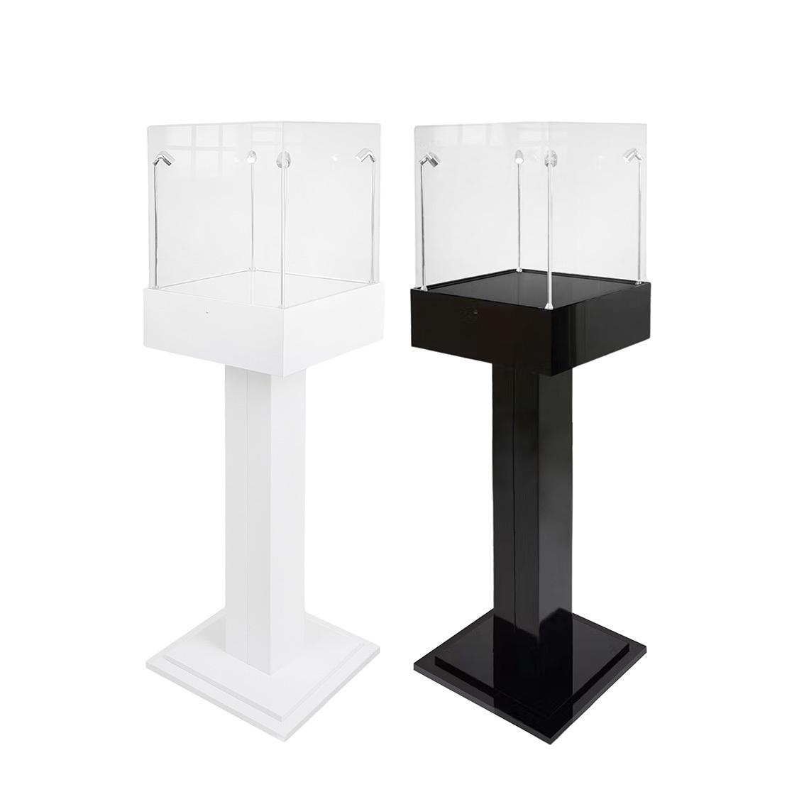 Black and white capped plinth display cases, each with four LED lights.