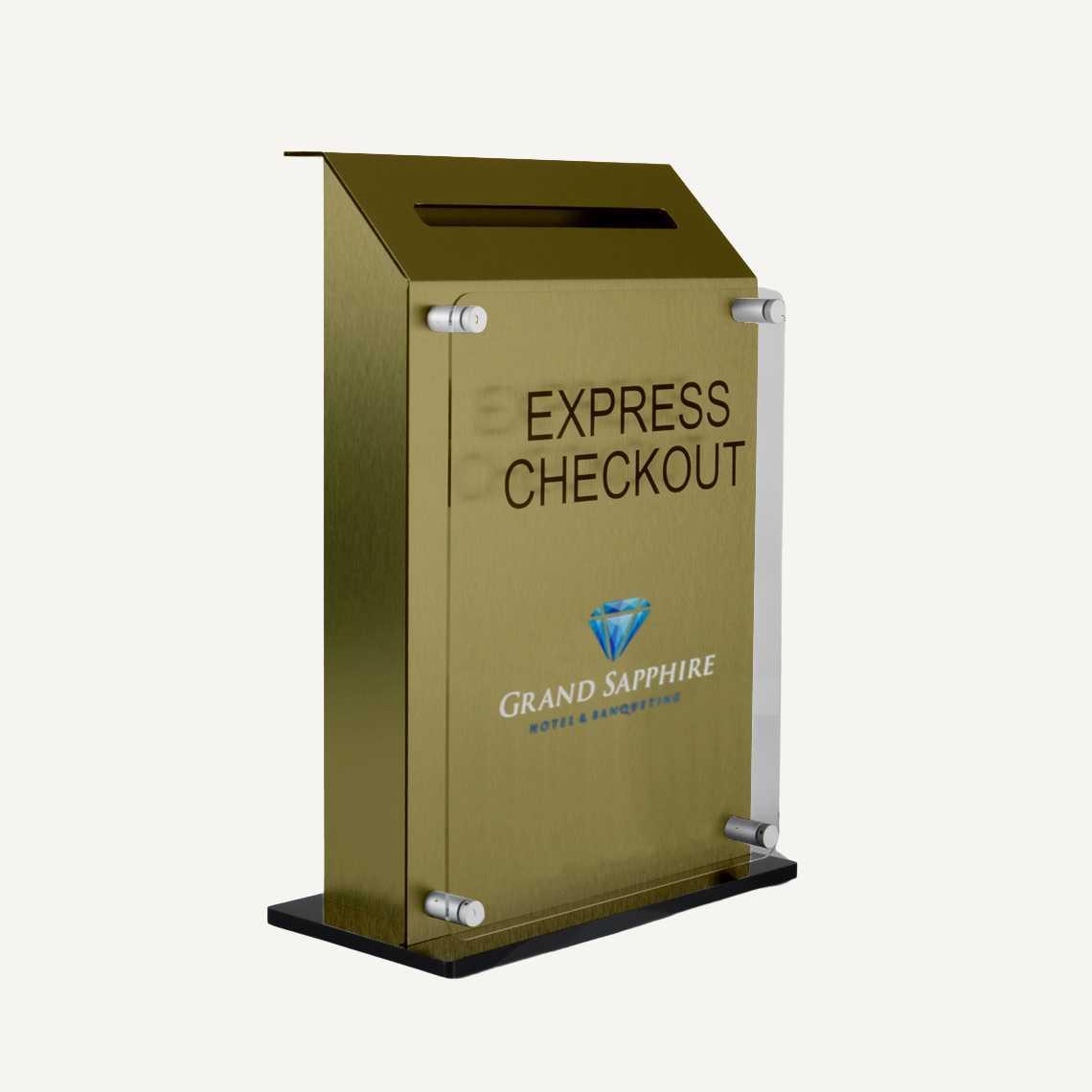 A gold countertop hotel key drop off box with logo.