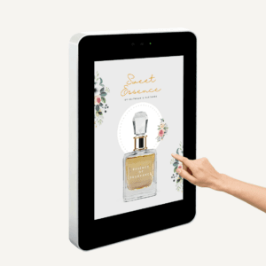 A hand pointing to a wall mounted outdoor interactive touch screen.