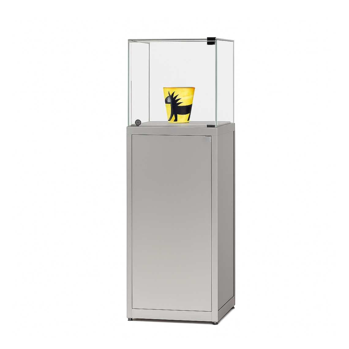 A silver display case plinth with a lockable, glass hinged door.