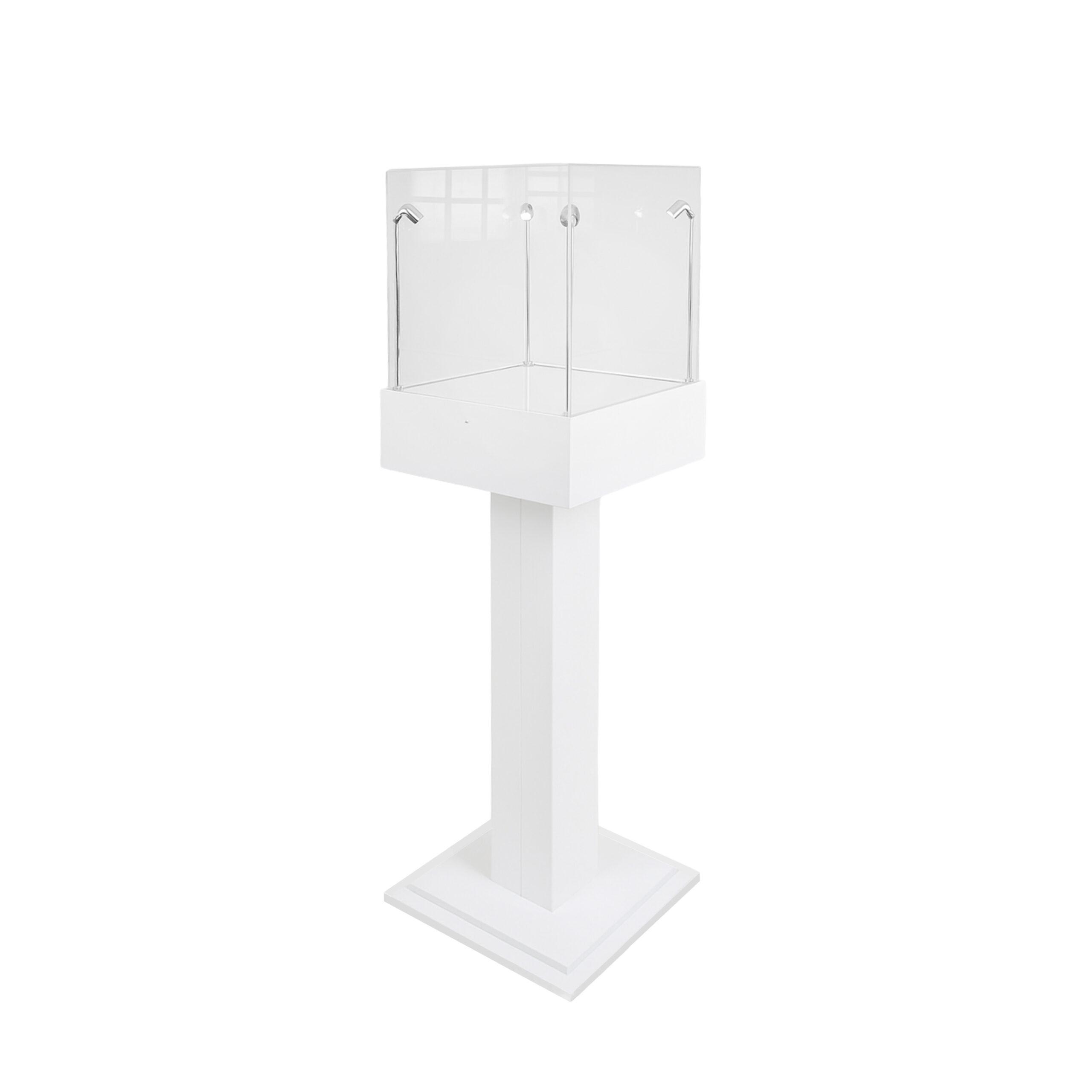 A white capped plinth display case with four lights.