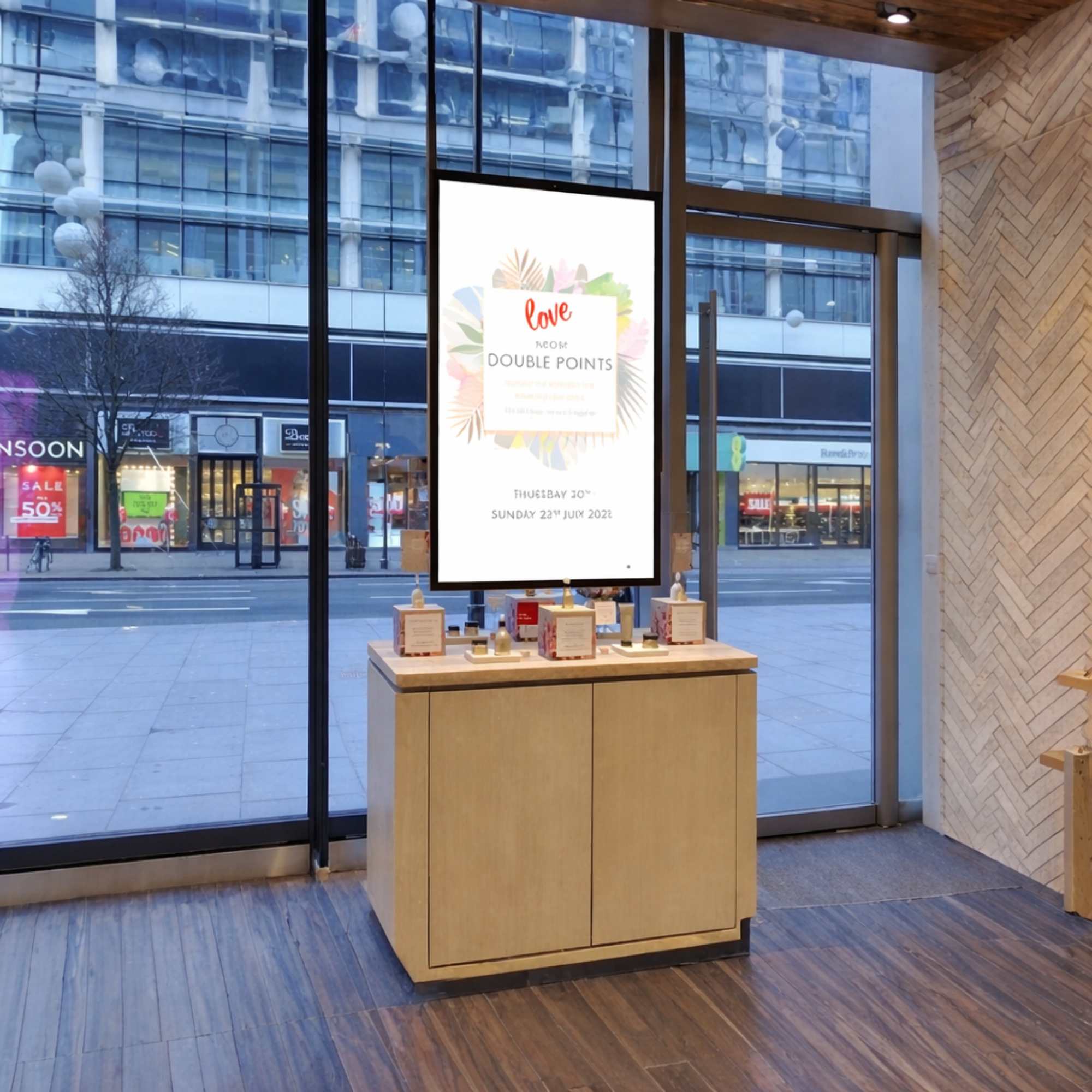 A ceiling hanging ultra-high-brightness double sided advertising screen in black inside of a shop.