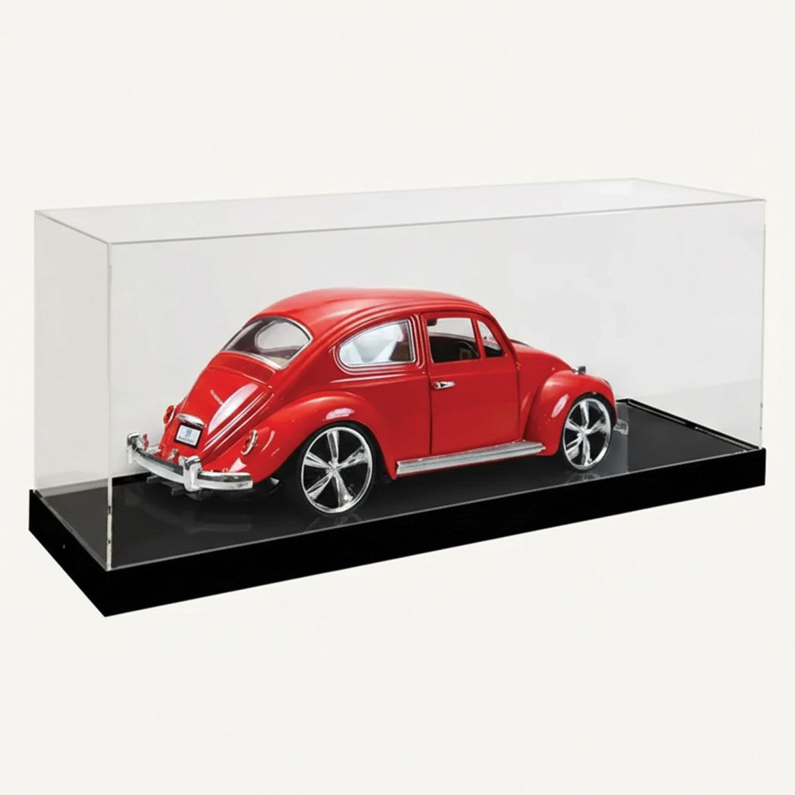 A model display case with a black base and a clear acrylic lid with a red car on display.