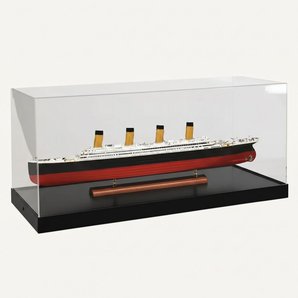 A model display case with a black base, a clear acrylic lid and a model boat on display.