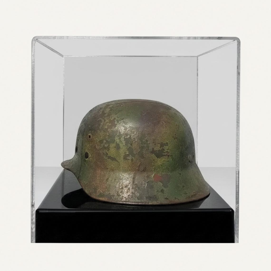 A display case with a black base, a clear acrylic lid and a historical helmet on display.