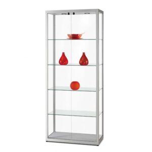 A silver glass display cabinet with sliding doors, two spotlights and vases and bowls on display.
