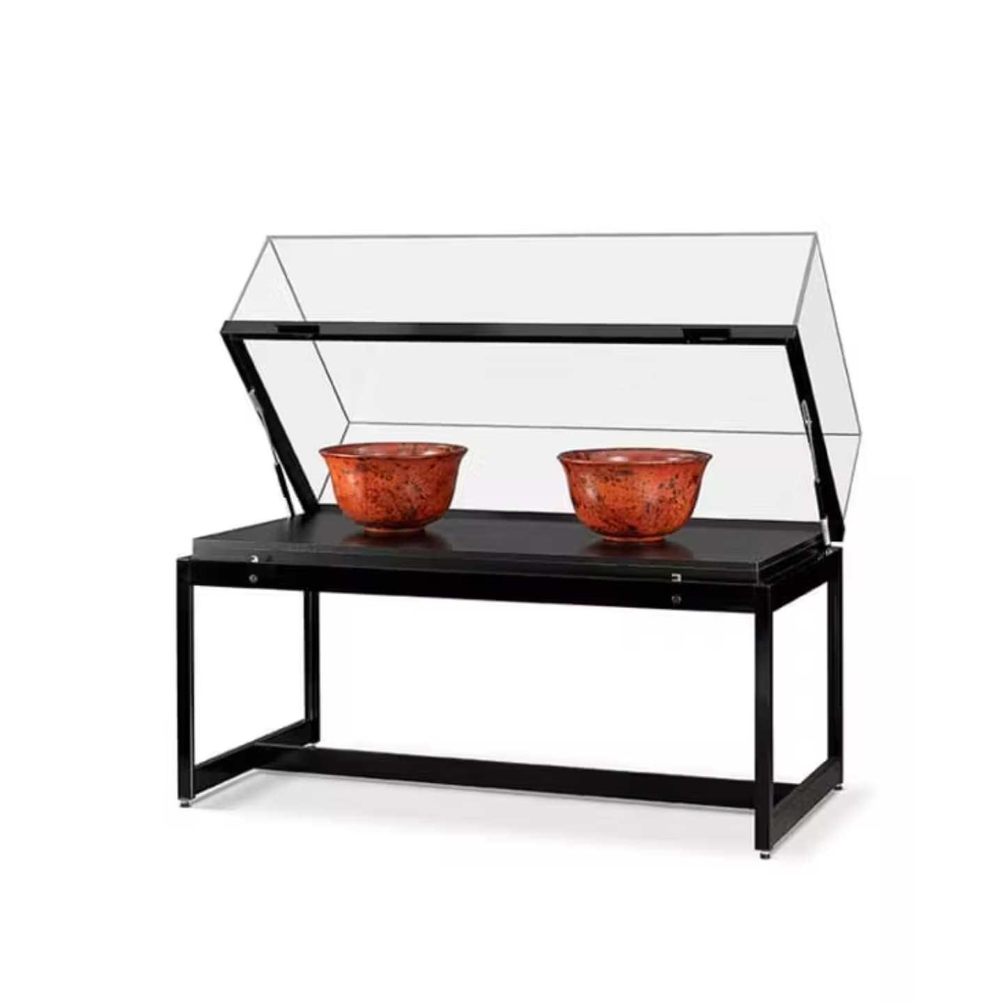 A black showcase table with decorative bowls inside.