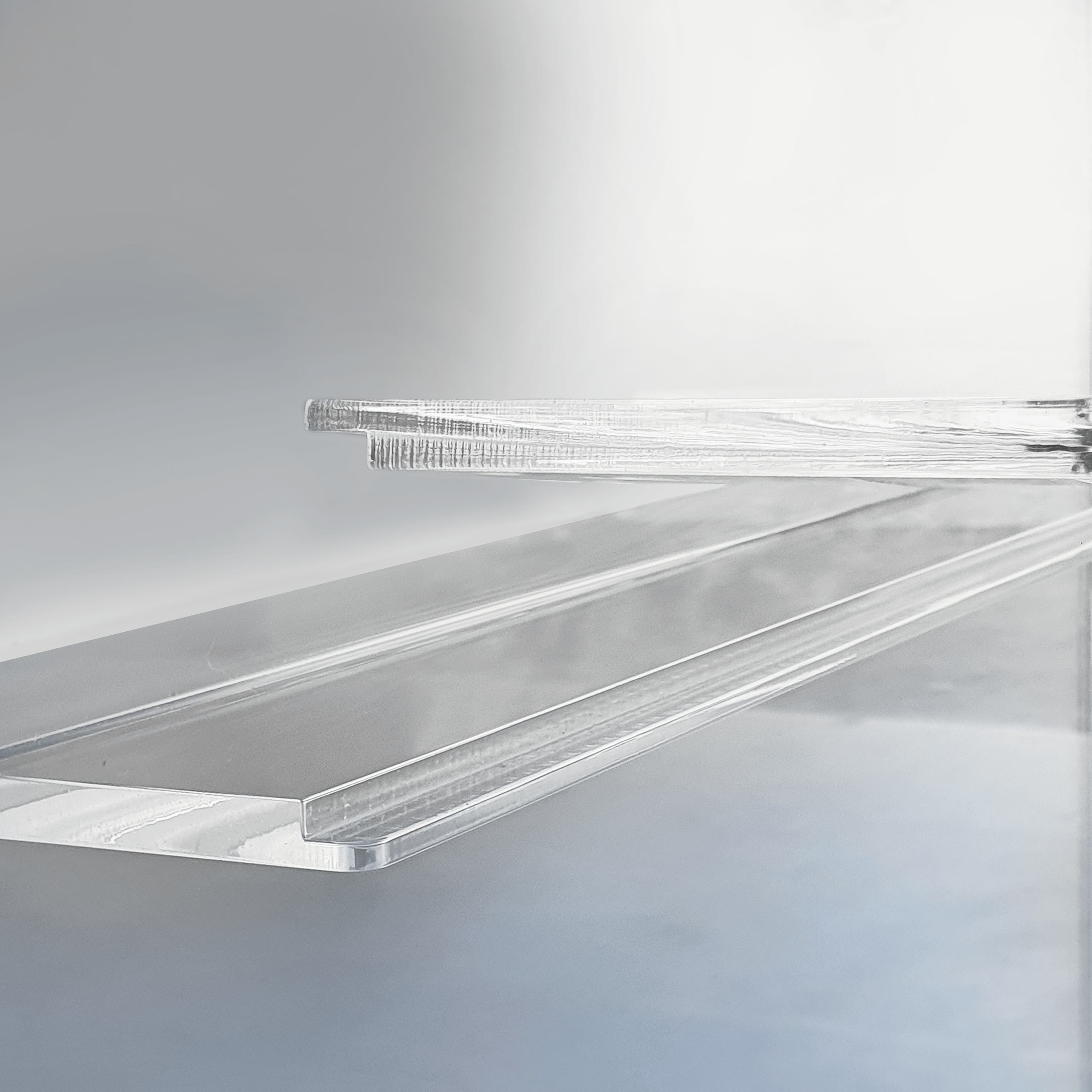 A close up of clear acrylic panels made for shelves on a display cabinet.