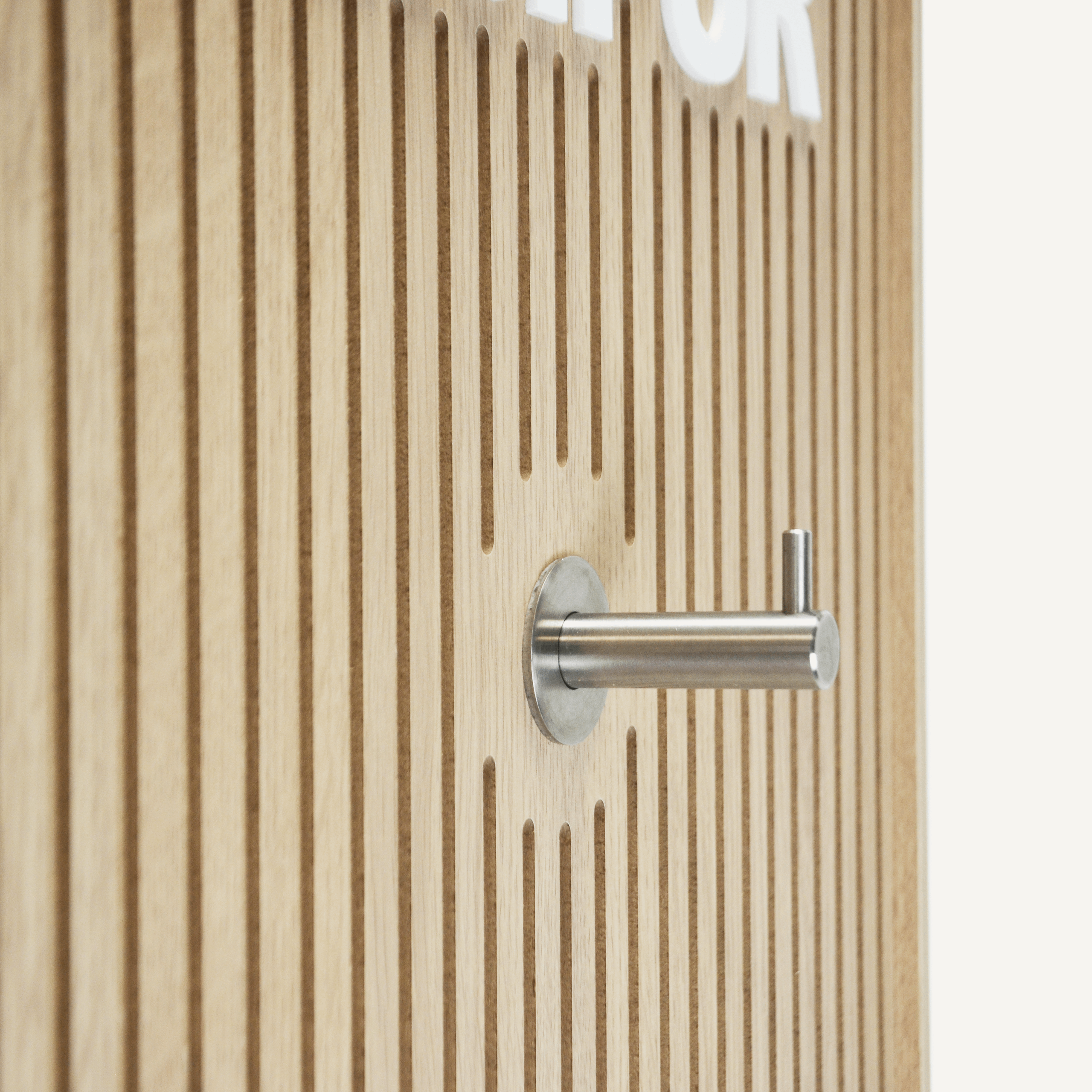 A close up of a chrome hook on a plywood finish rotating POS display.