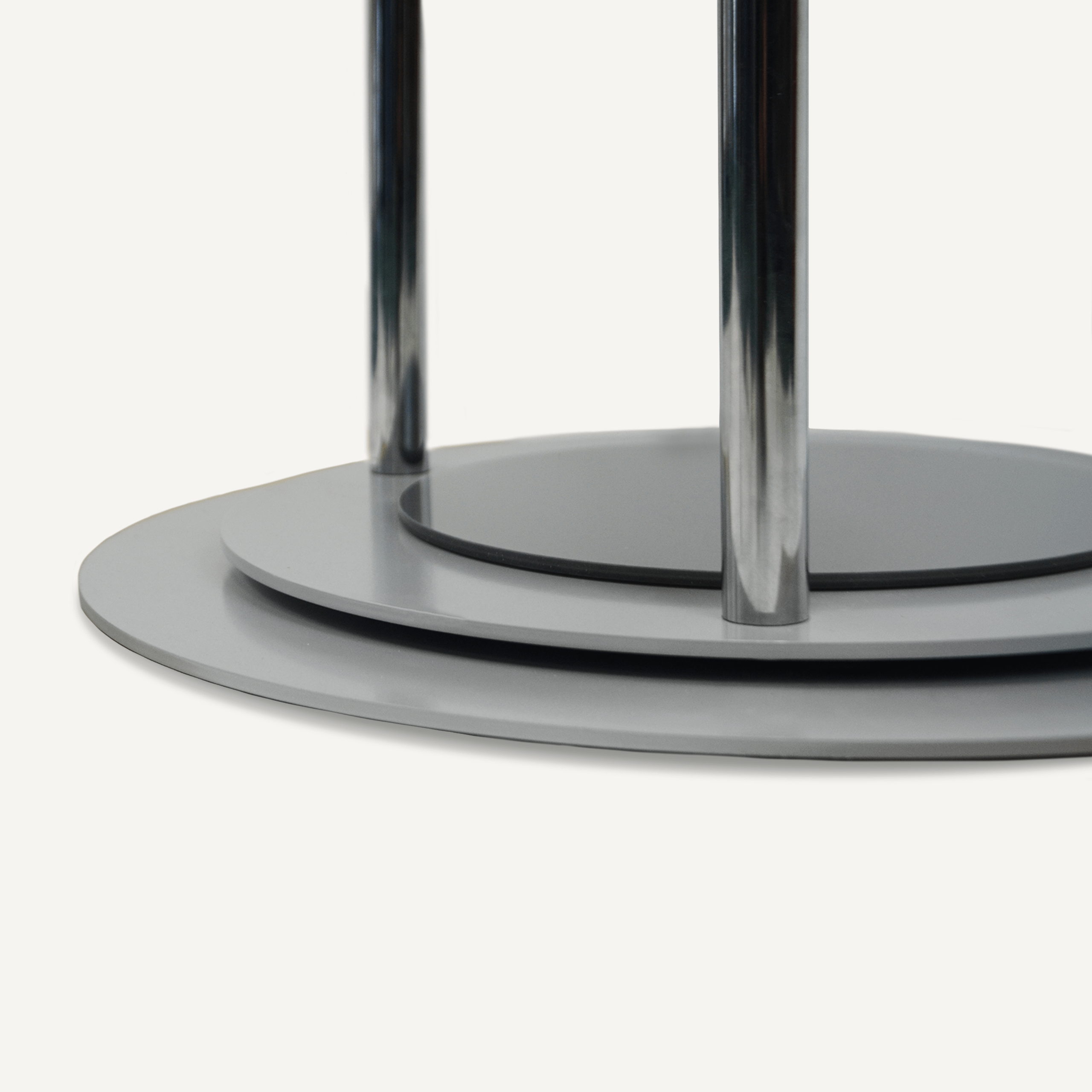 A close up of a chrome rotating base on a rotating POS display.