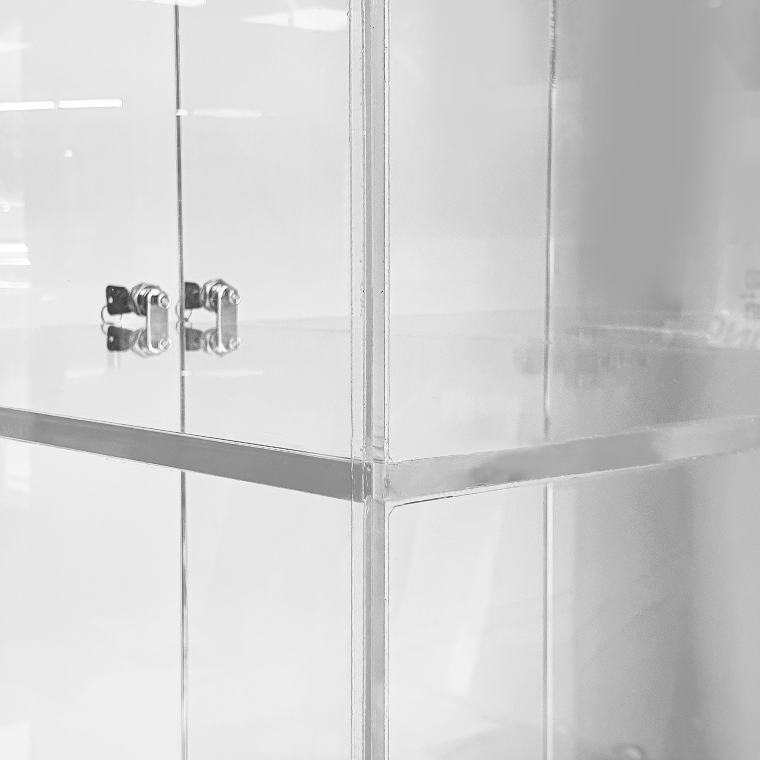 A close up of acrylic storage compartments on an acrylic custom display cabinet.