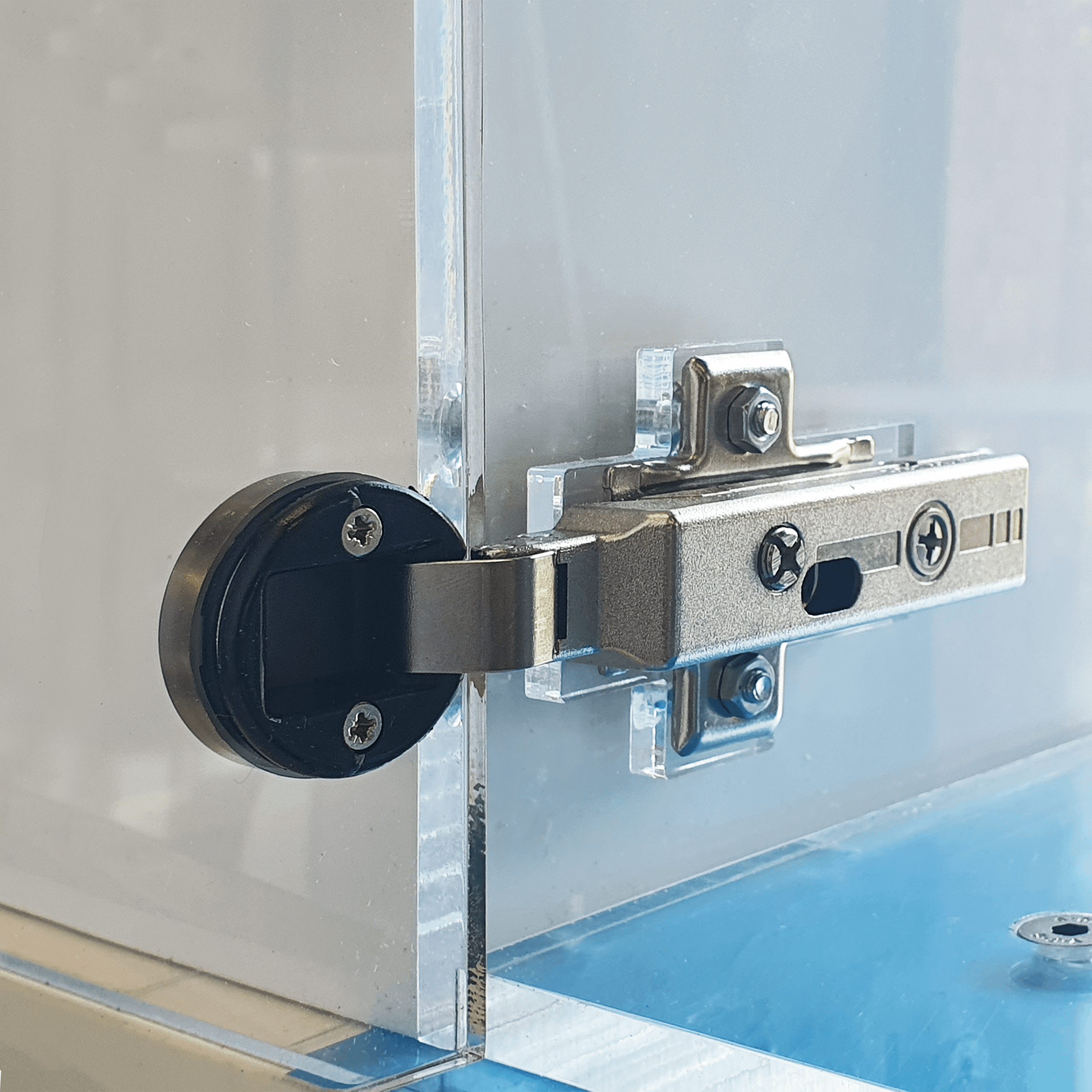 A close up of the door mechanism on an acrylic custom display cabinet.