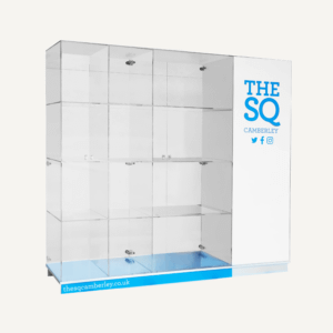 An acrylic custom display cabinet with The SQ Camberley logo and branding, with a blue base and lockable cabinet doors.