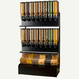 A front facing view of a 16 cylinder, 6 container black and clear bulk dry food dispenser filled with different types of dried foods.