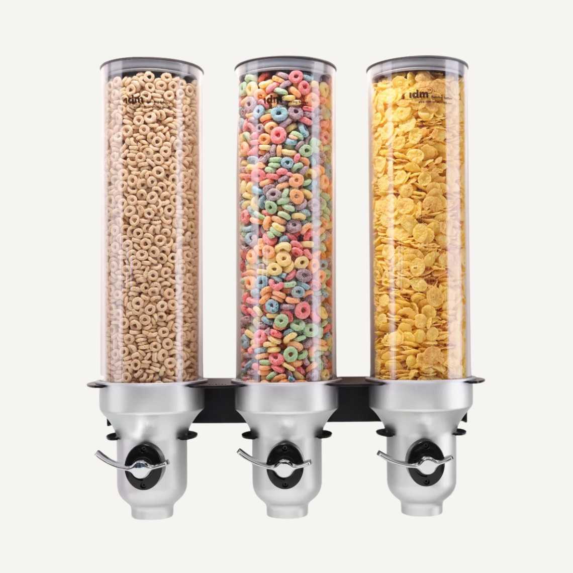 A front facing picture of a black and silver, three cylinder, wall mounted cereal dispenser with different cereals inside.
