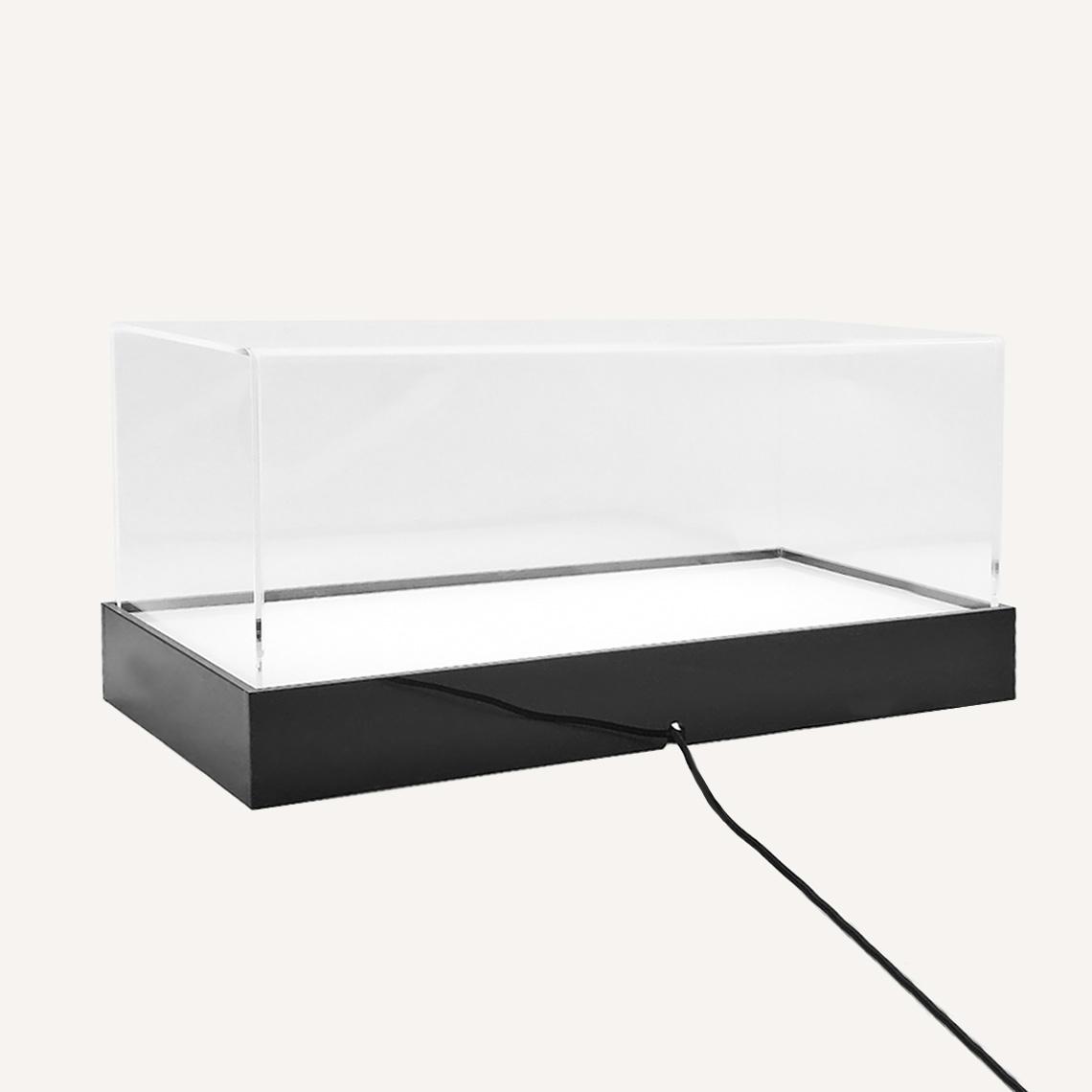 Illuminated Case with clear top and black base and power cord.