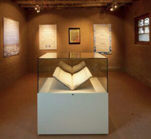 A museum exhibition display of a book in a display case.
