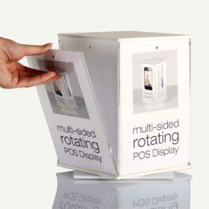 A rotating POS Display with a hand removing a pocket from its magnetic trap.