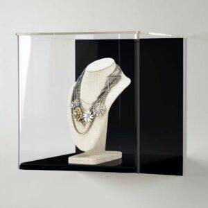 Necklace in a wall mounted display case.