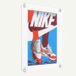 A retro looking Nike poster in a white acrylic frame.