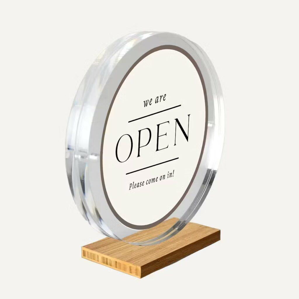 A magnetic circular frame with a wooden base.